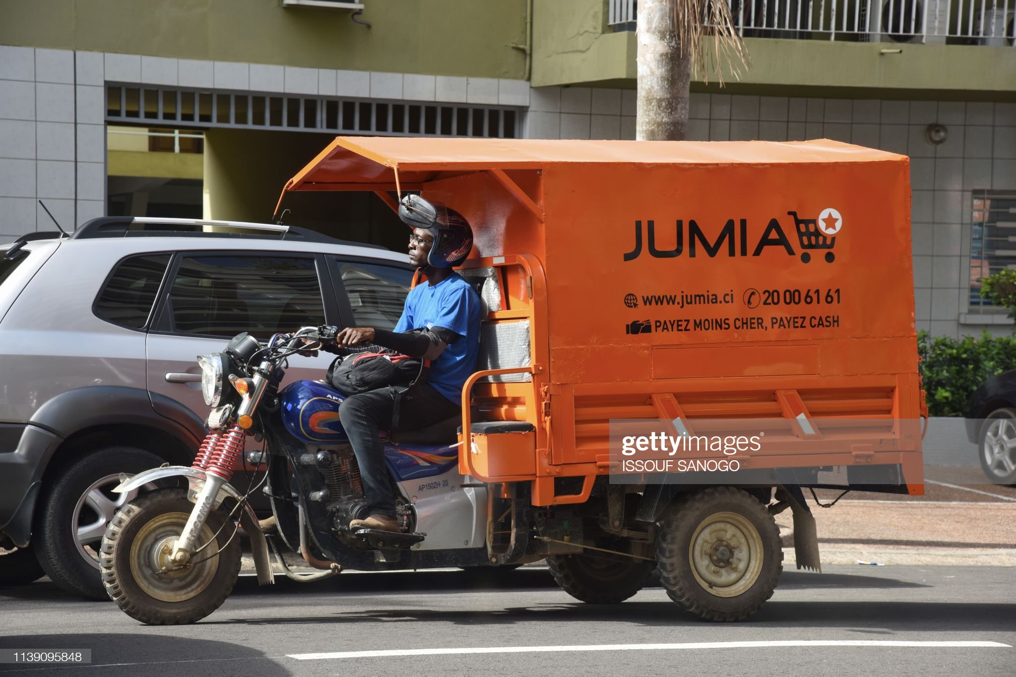A delivery man drives a transporter with an advertisement for Nigeria's e-commerce site Jumia in the Plateau district of Abidjan on April 24, 2019. - Jumia, the e-commerce site based in Nigeria, became on April 12, 2019 the first African start-up to make its debut on Wall Street. (Photo by ISSOUF SANOGO / AFP)        (Photo credit should read ISSOUF SANOGO/AFP via Getty Images)