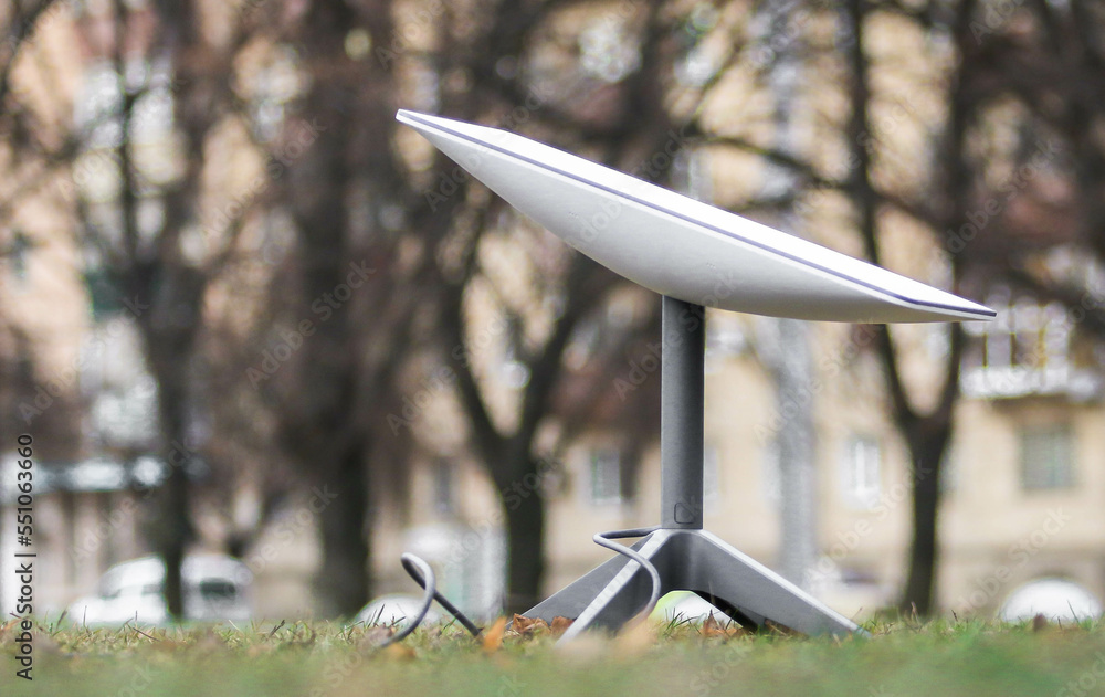 A Starlink antenna for receiving the Internet signal from space Starlink on the ground in the park
