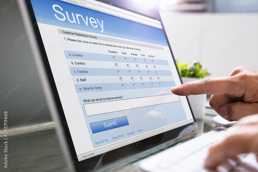 Man Giving Online Survey On Laptop