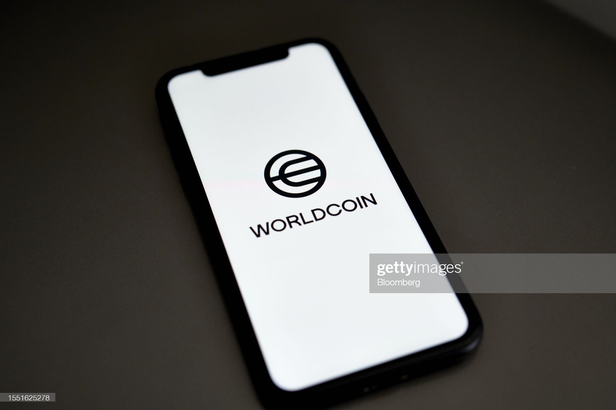 The Worldcoin logo on a smartphone arranged in Germantown, New York, US, on Monday, July 24, 2023. Worldcoin, the digital identity and crypto payments project co-founded by OpenAI Chief Executive Officer Sam Altman, launched on Monday. Photographer: Gabby Jones/Bloomberg via Getty Images